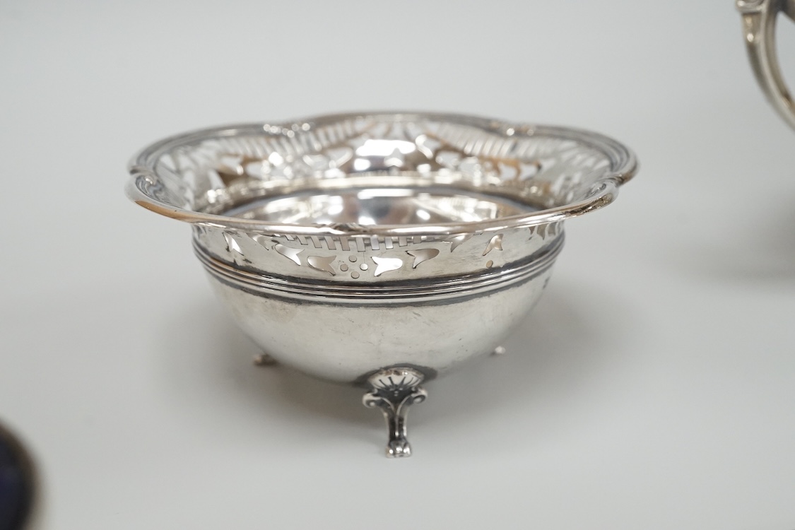 A George V silver mounted capstan inkwell, A & J Zimmerman Ltd, Birmingham, 1913, diameter 11.4cm, together with a small silver bowl, a small silver 'dish ring' salt(a.f.), a silver two handled bowl, a silver pill box an